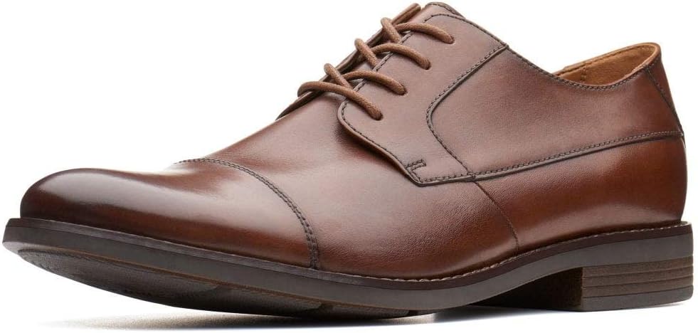 Pavo Monitor Arm installed on a wooden desk showing adjustable range